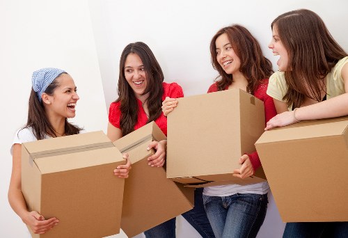 Removal team moving items through a London apartment building