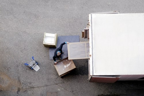 Local movers organizing packed household items for transport in London