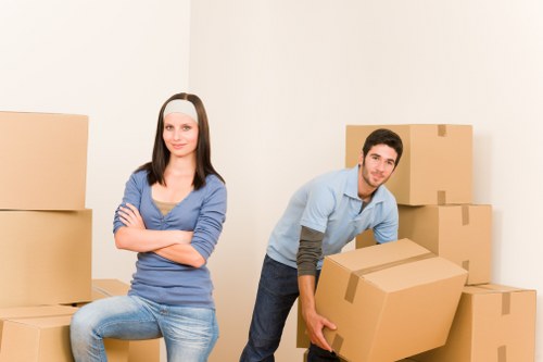 Professional movers handling furniture in a London flat