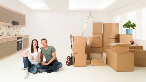 Local movers handling furniture in a London street