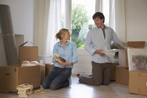 Movers handling furniture in a London property with tight access