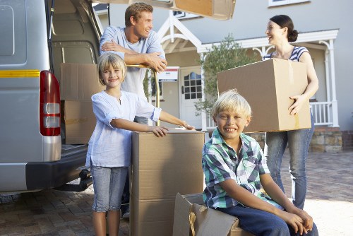 London removals crew handling furniture near a residential property