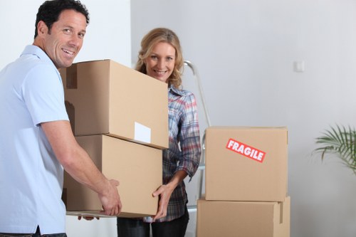 Home removal team transporting boxes and furniture in London